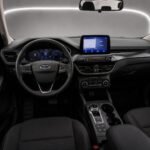 Interior of a 2023 Ford Kuga with steering wheel, digital displays and central touchscreen
