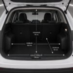 Open boot of a white Ford Kuga with labeled measurements