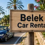 Belek Car Rental: Sign and Mediterranean Roadside Scene Wooden sign reading “Belek Car Rental” beside a blue car, palm trees and a coastal landscape.