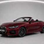 Red BMW 430i Cabrio convertible car shown in studio from front and side