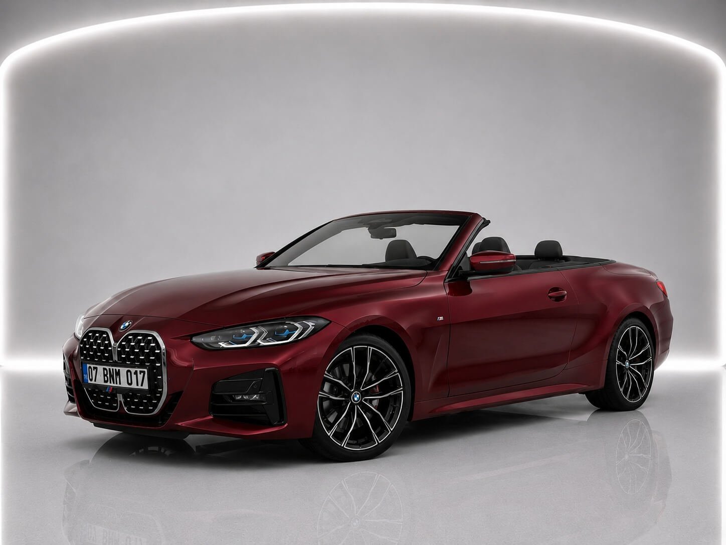 Red BMW 430i Cabrio convertible car shown in studio from front and side